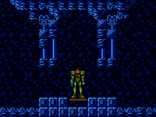 A screencap from the game Super Metroid. Samus Aran stands at the bottom of an empty elevator shaft, deep underground. Her visor glows in the darkness. There is nothing and no one else around.