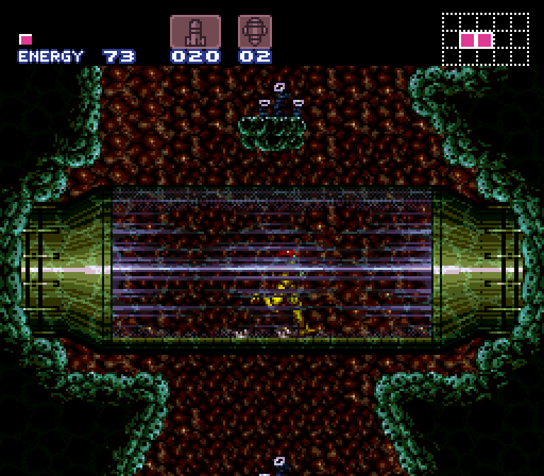 A screenshot from the game Super Metroid. Samus Aran runs through a transparent glass tunnel. It appears to be a protected path through an underwater cavern.